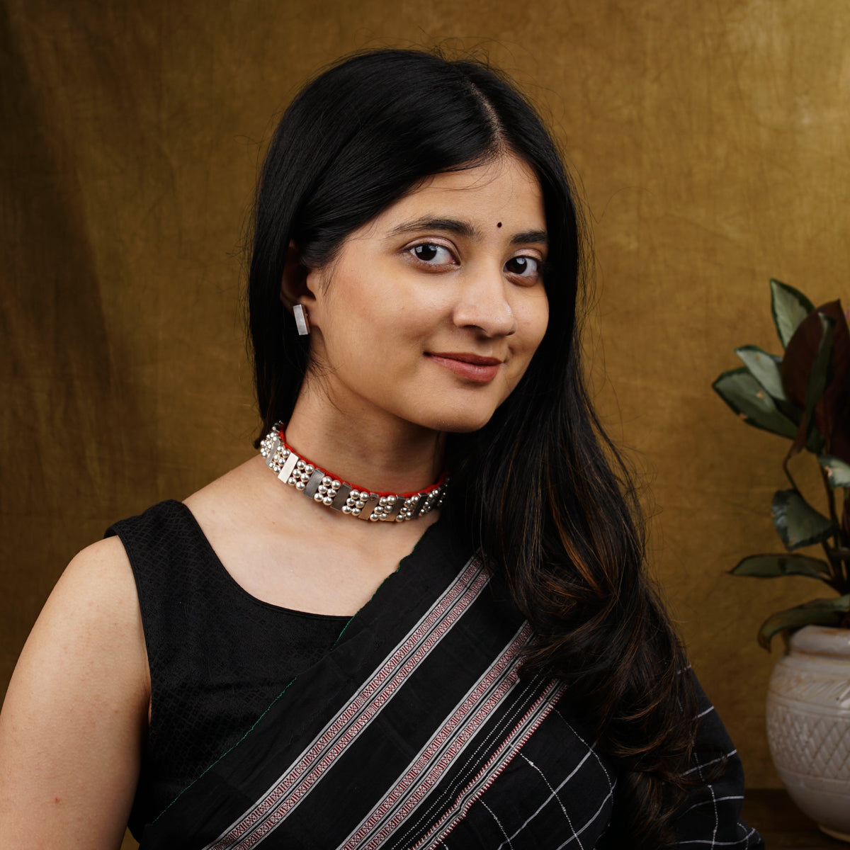 a woman in a black and white sari posing for a picture
