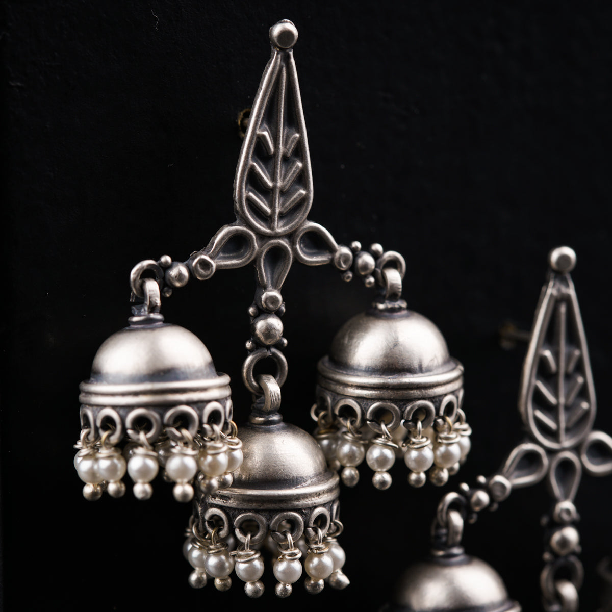 a group of silver bells sitting on top of a table