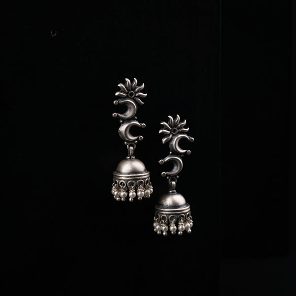 a pair of silver bells on a black background