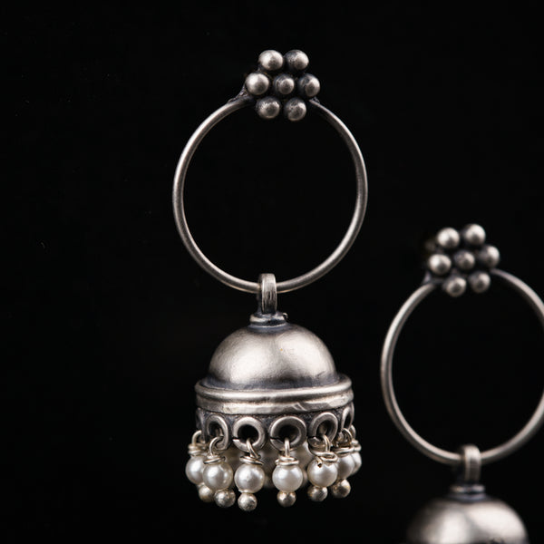 a pair of silver bells on a black background