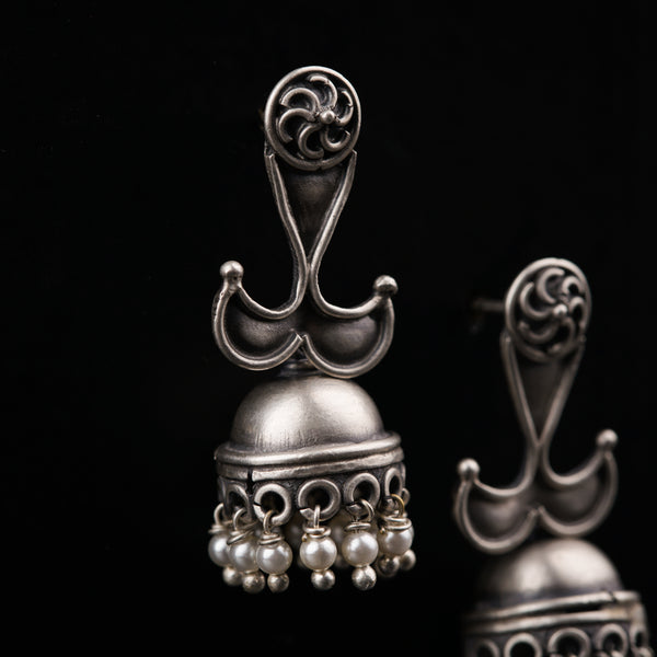 a pair of silver bells on a black background