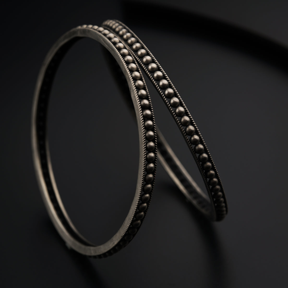 a close up of a metal object on a black surface