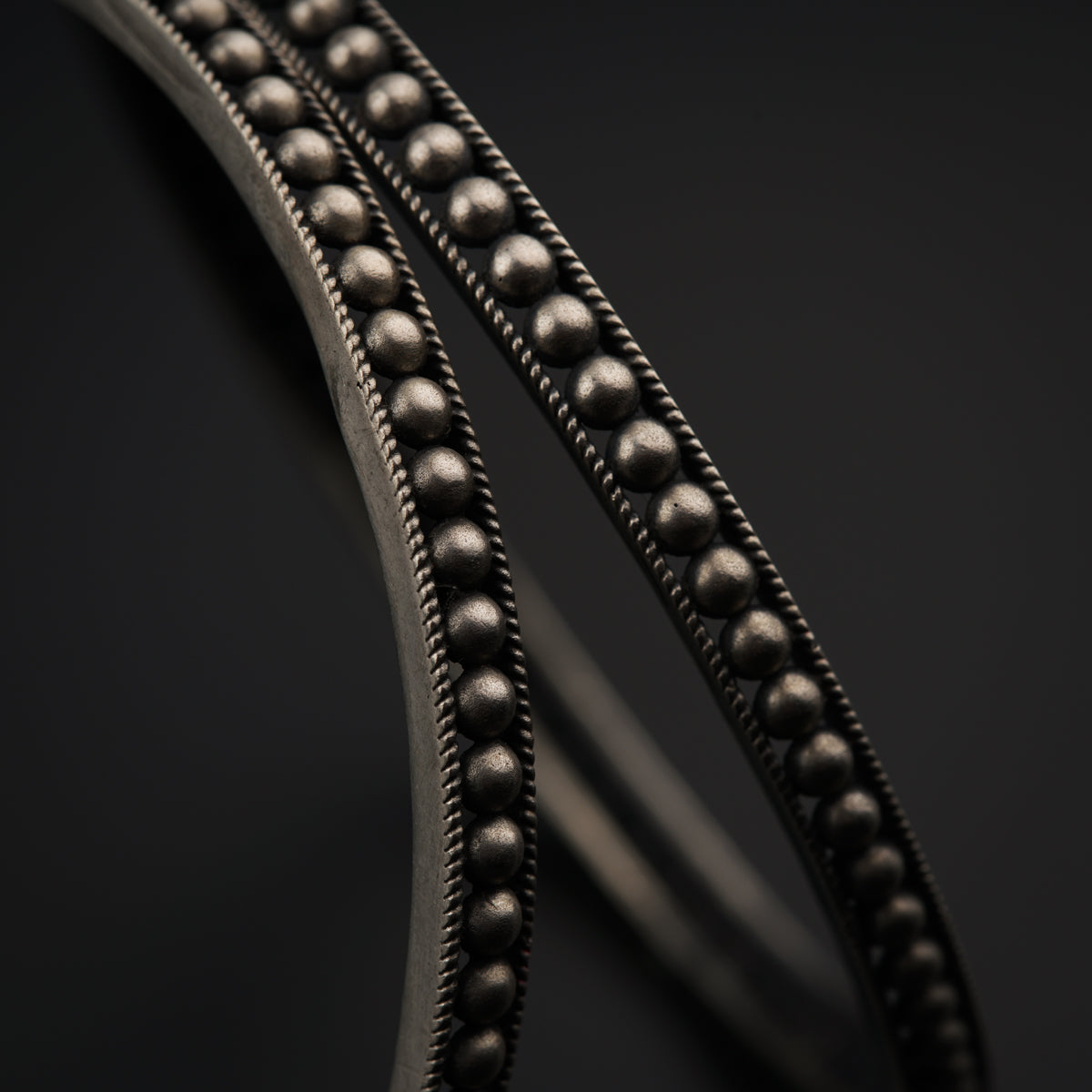 a close up of a metal object on a black surface