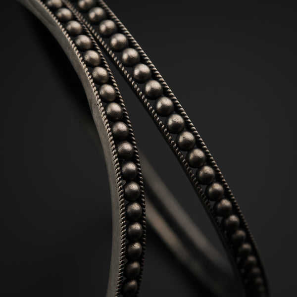 a close up of a metal object on a black surface
