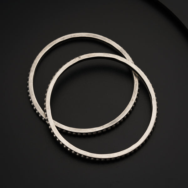 a close up of a stack of metal rings on a black surface