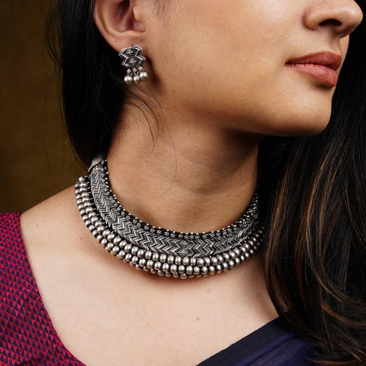 a close up of a woman wearing a necklace