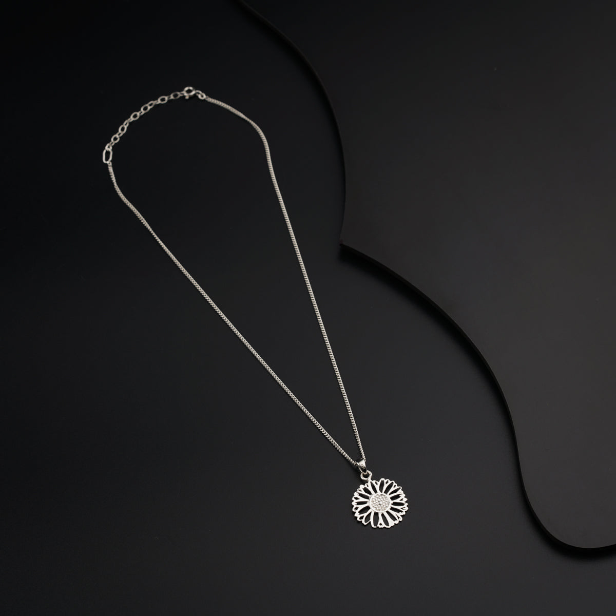 a necklace that has a flower on it