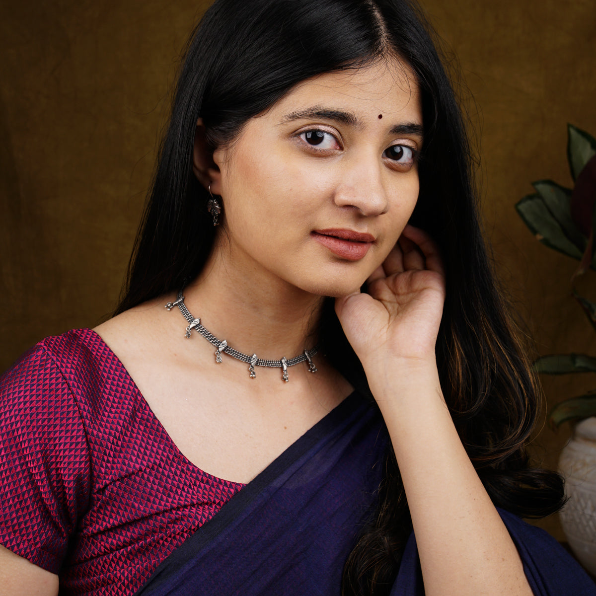 a woman in a purple sari poses for a picture