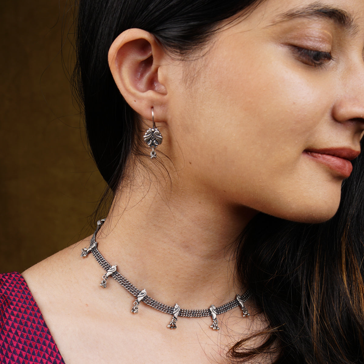 a close up of a woman wearing a necklace