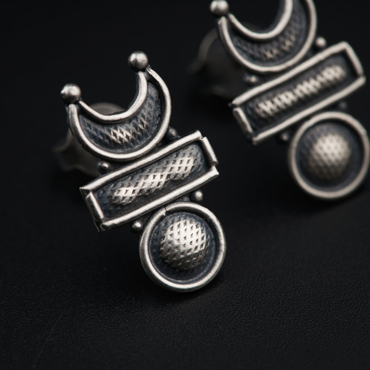 a pair of earrings sitting on top of a table