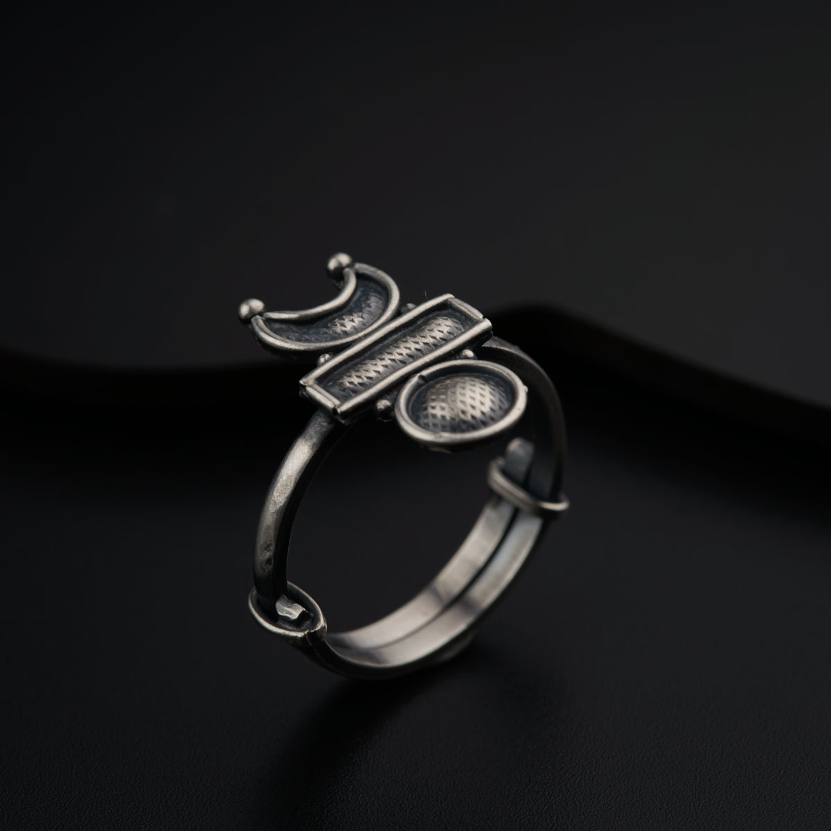 a close up of a ring on a black surface