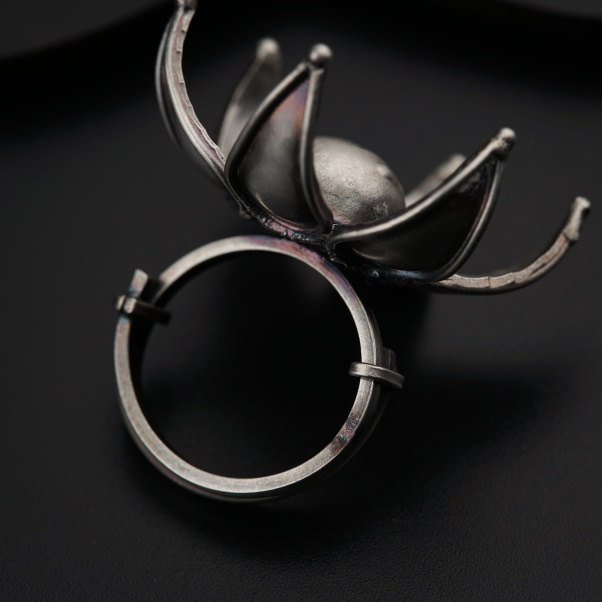 a pair of silver rings sitting on top of a table