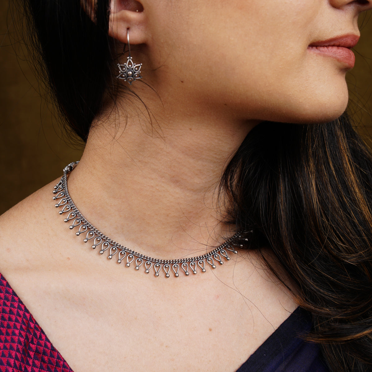 a close up of a woman wearing a necklace