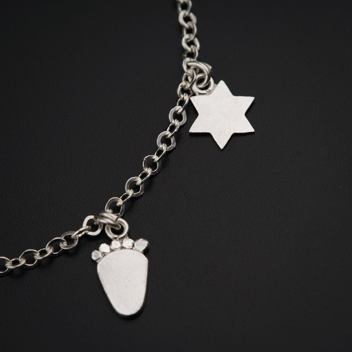 a close up of a chain with a charm on it