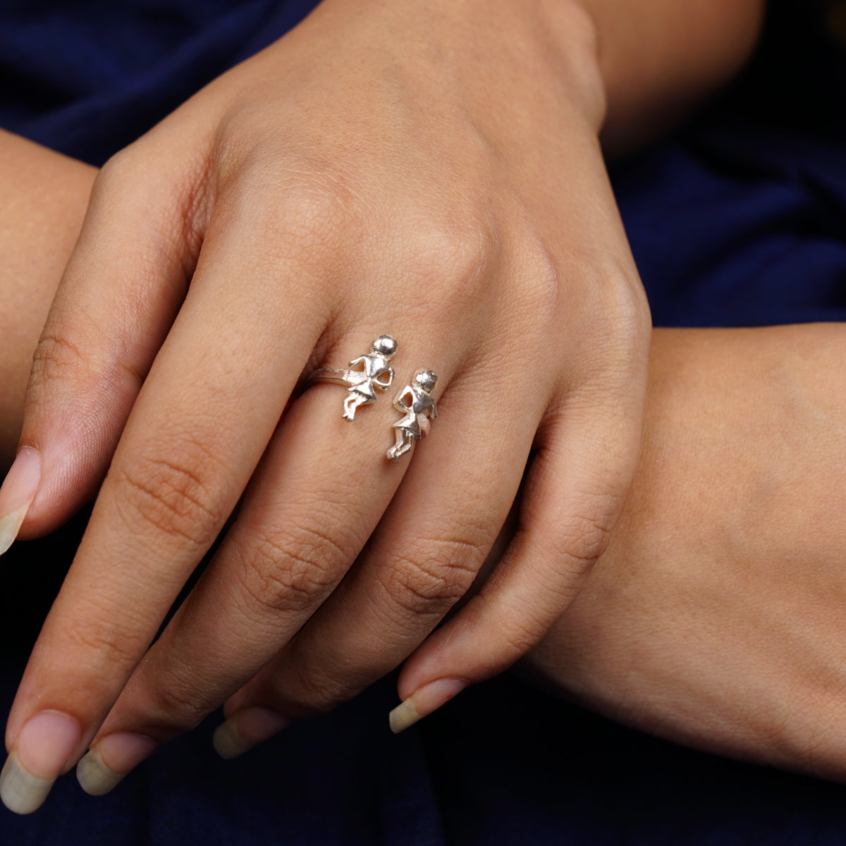 a close up of a person's hand with a ring on it