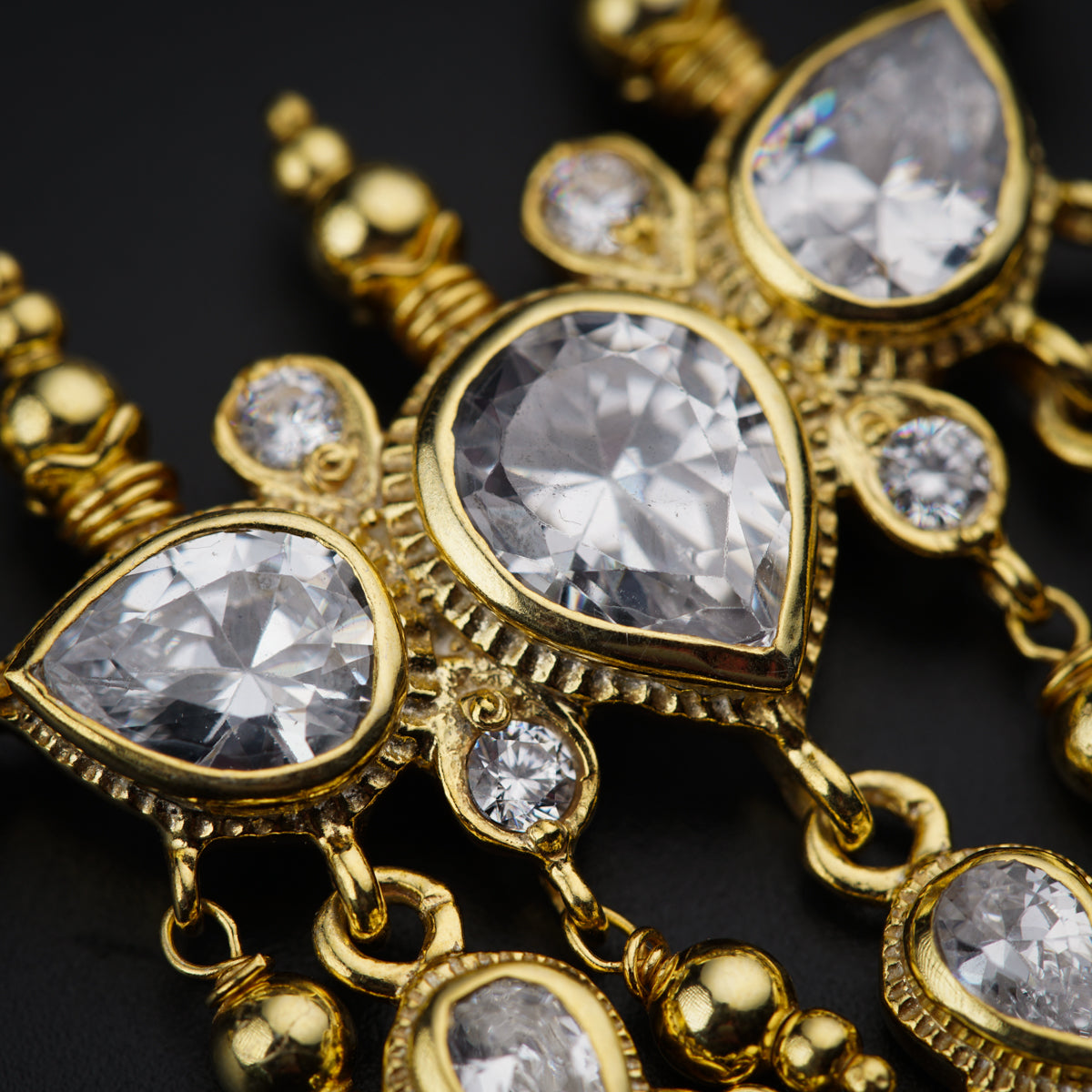 a close up of a gold necklace with diamonds