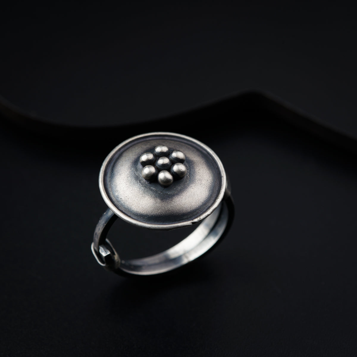 a silver ring with a flower on it