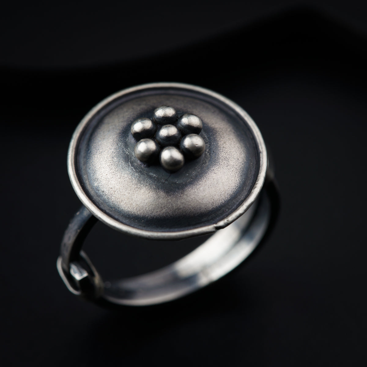 a close up of a ring on a black surface