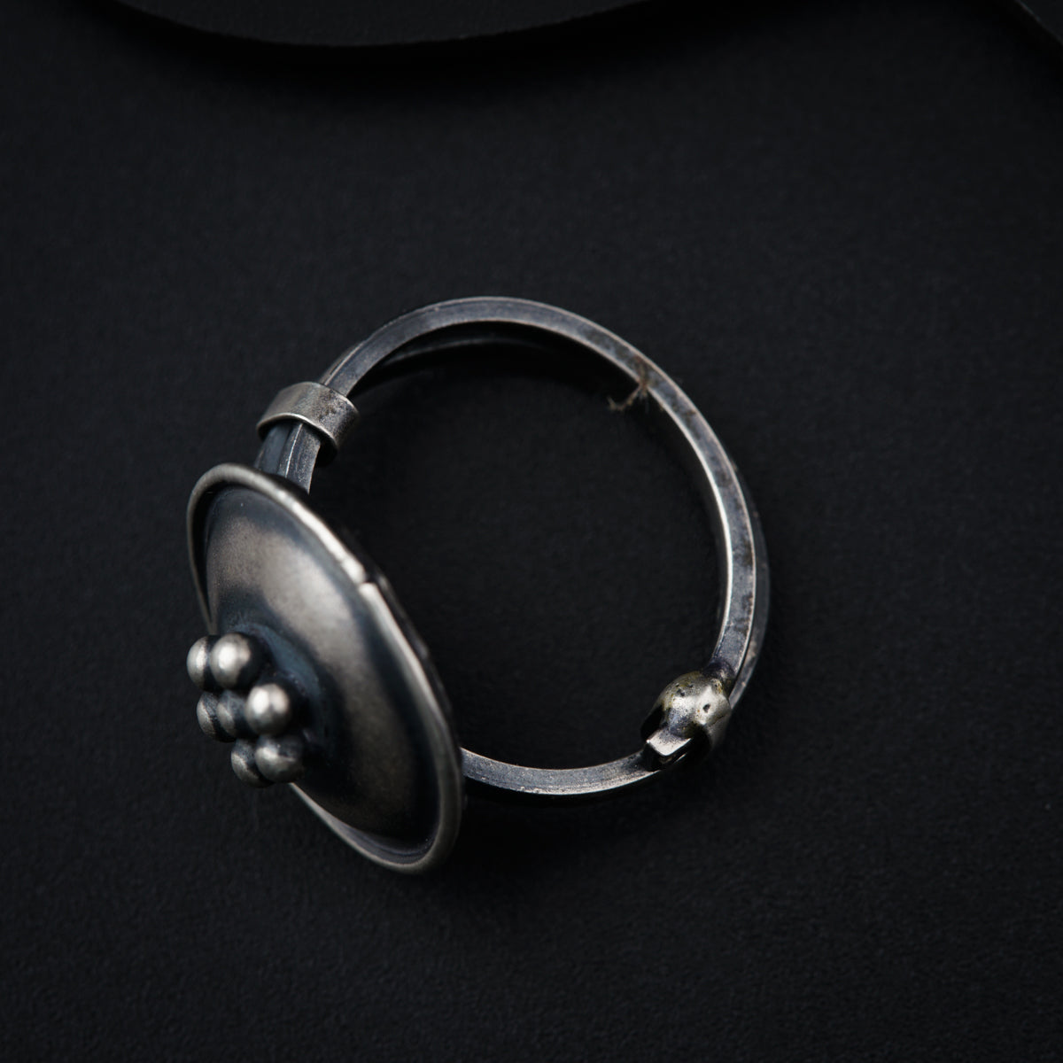 a metal object on a black surface