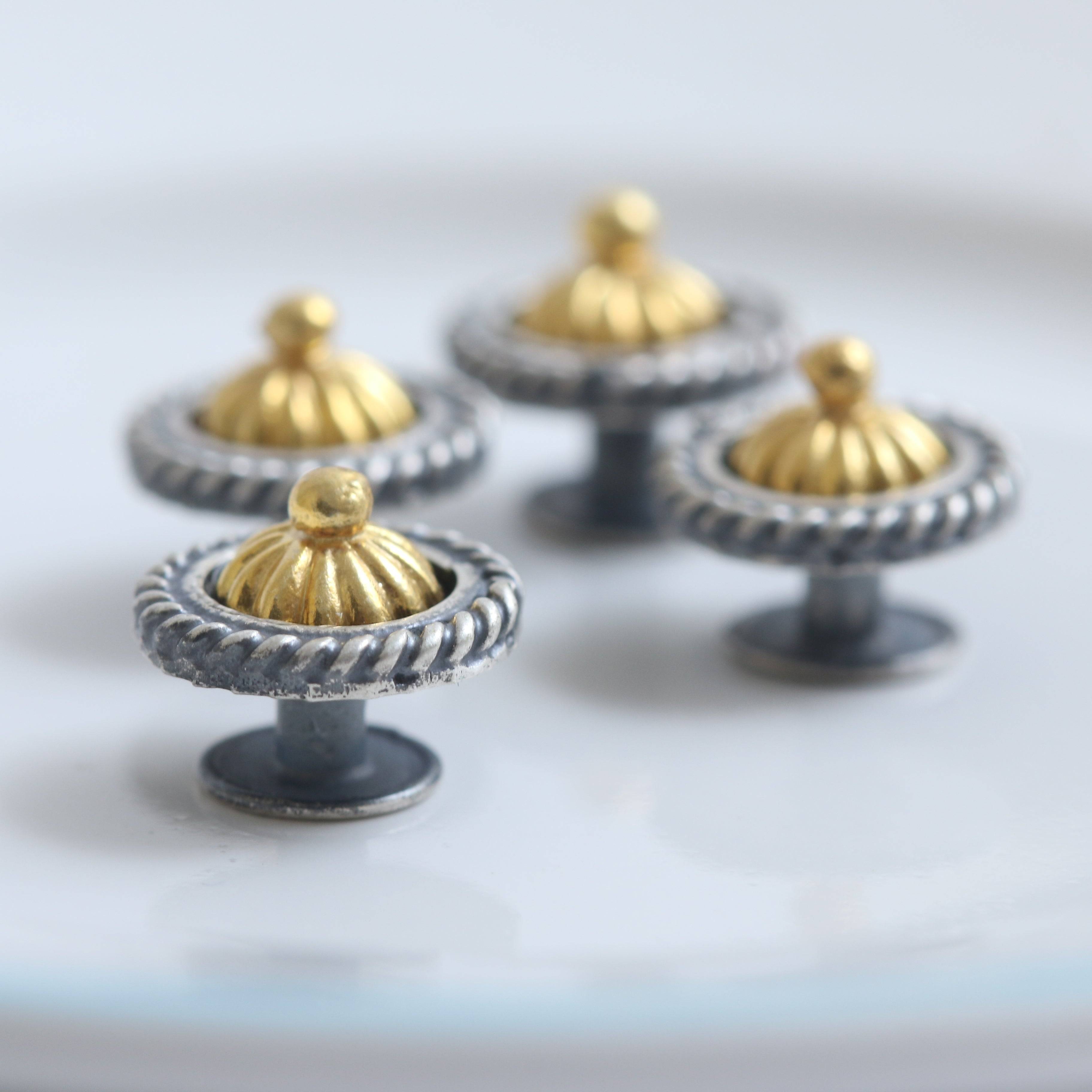 a close up of three metal knobs on a plate