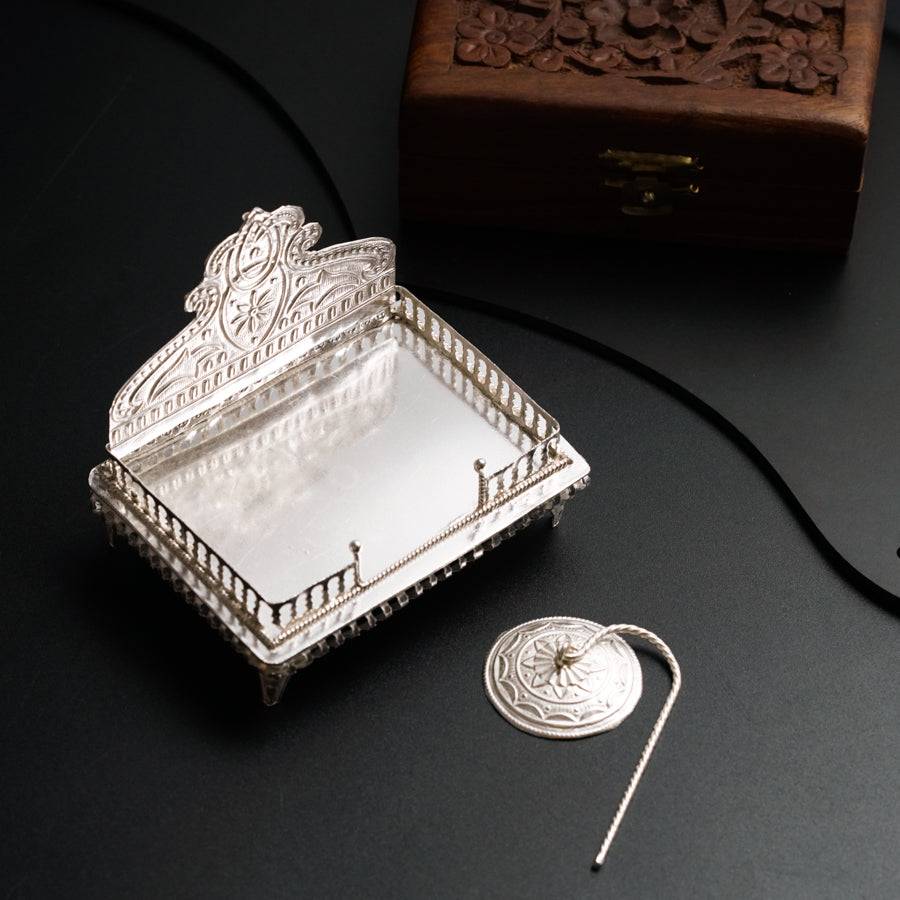 a silver tray with a mirror on top of it