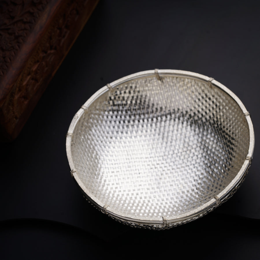 a metal bowl sitting on top of a table