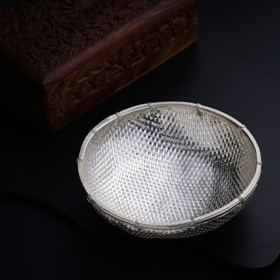 a silver bowl sitting on top of a table