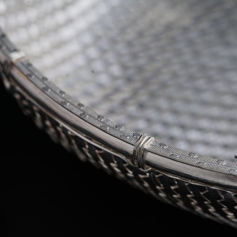 a close up of a metal object with a black background