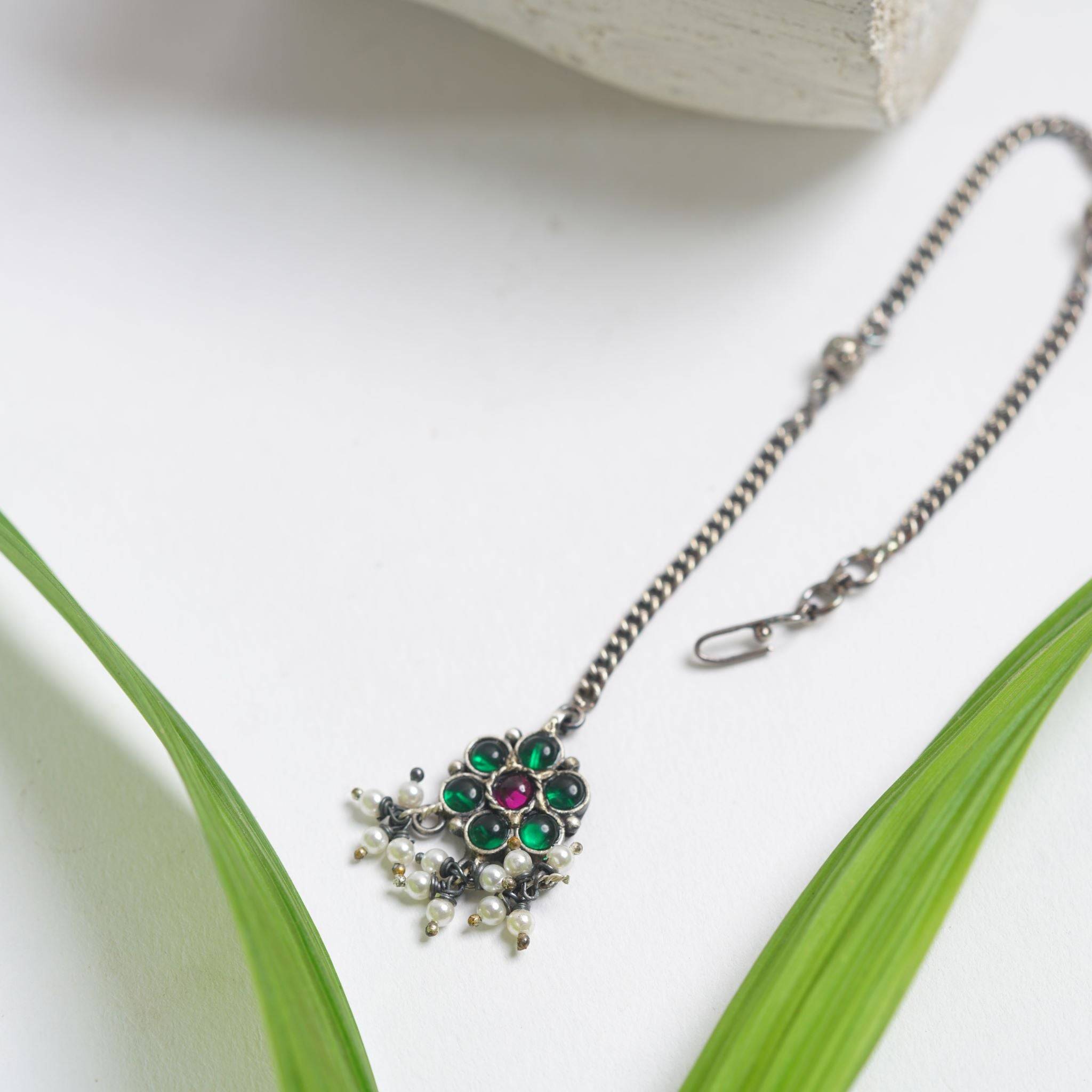 a close up of a necklace on a table