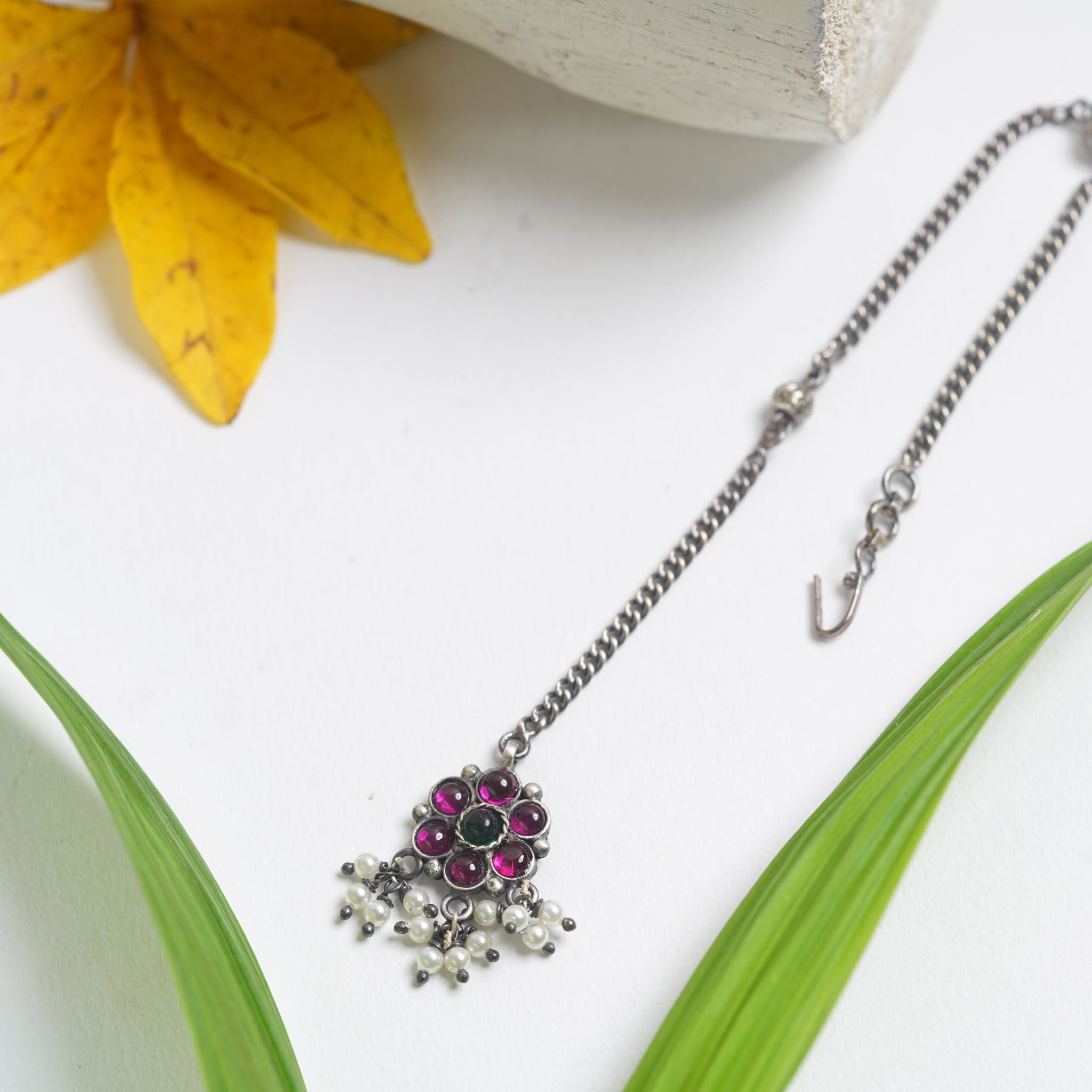 a close up of a necklace on a table