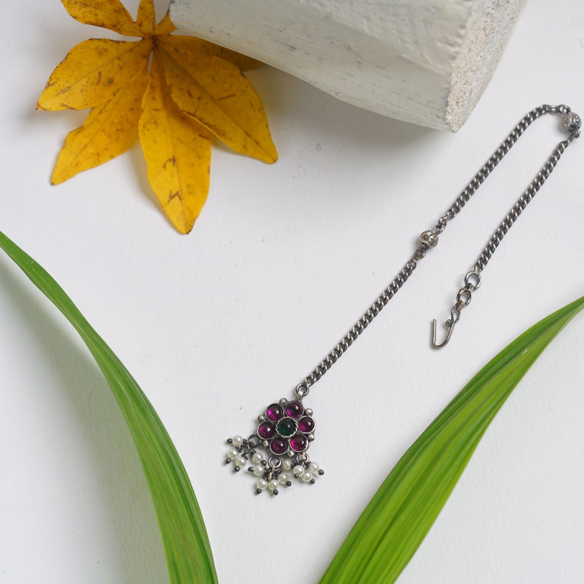 a close up of a necklace on a table