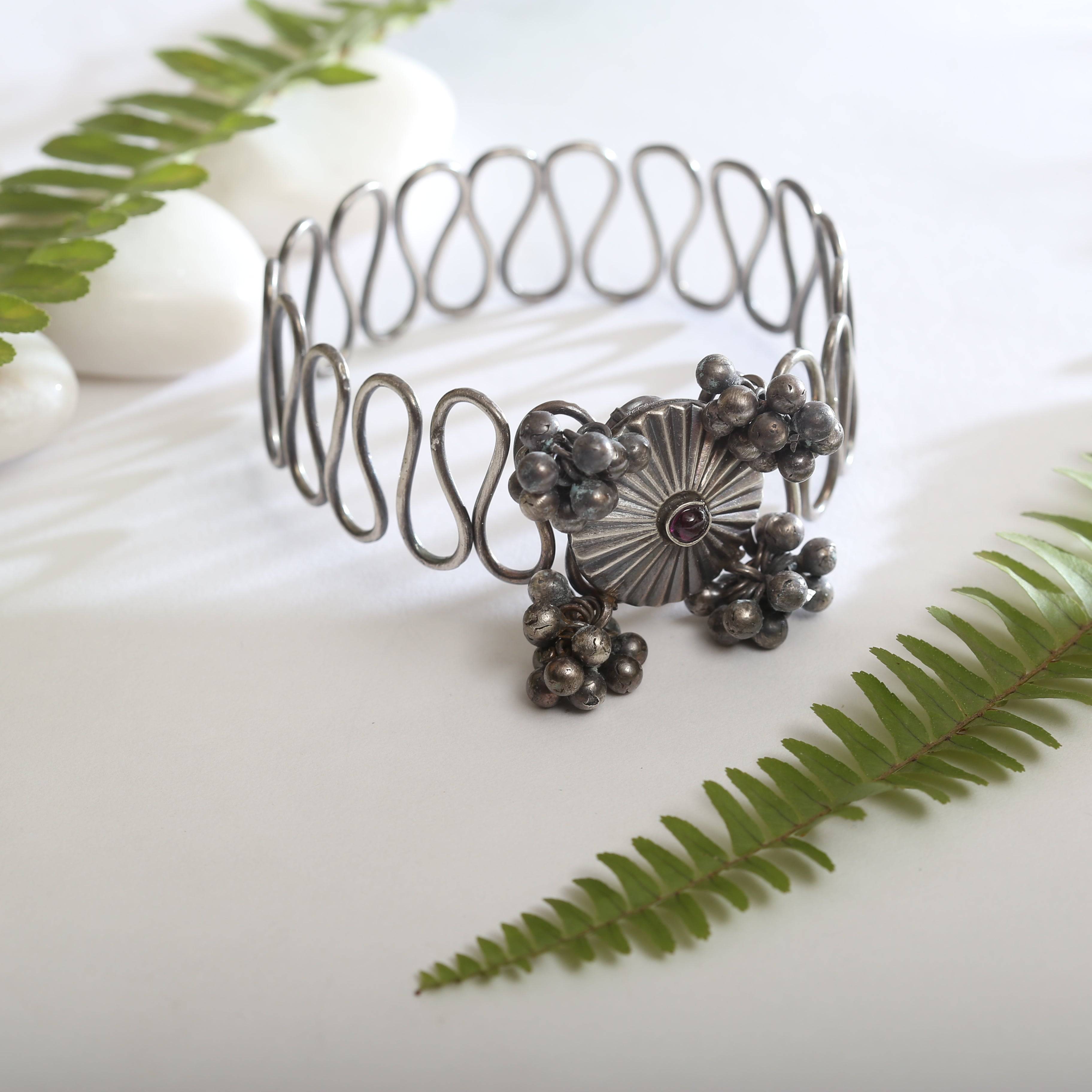 a close up of a metal bracelet on a table