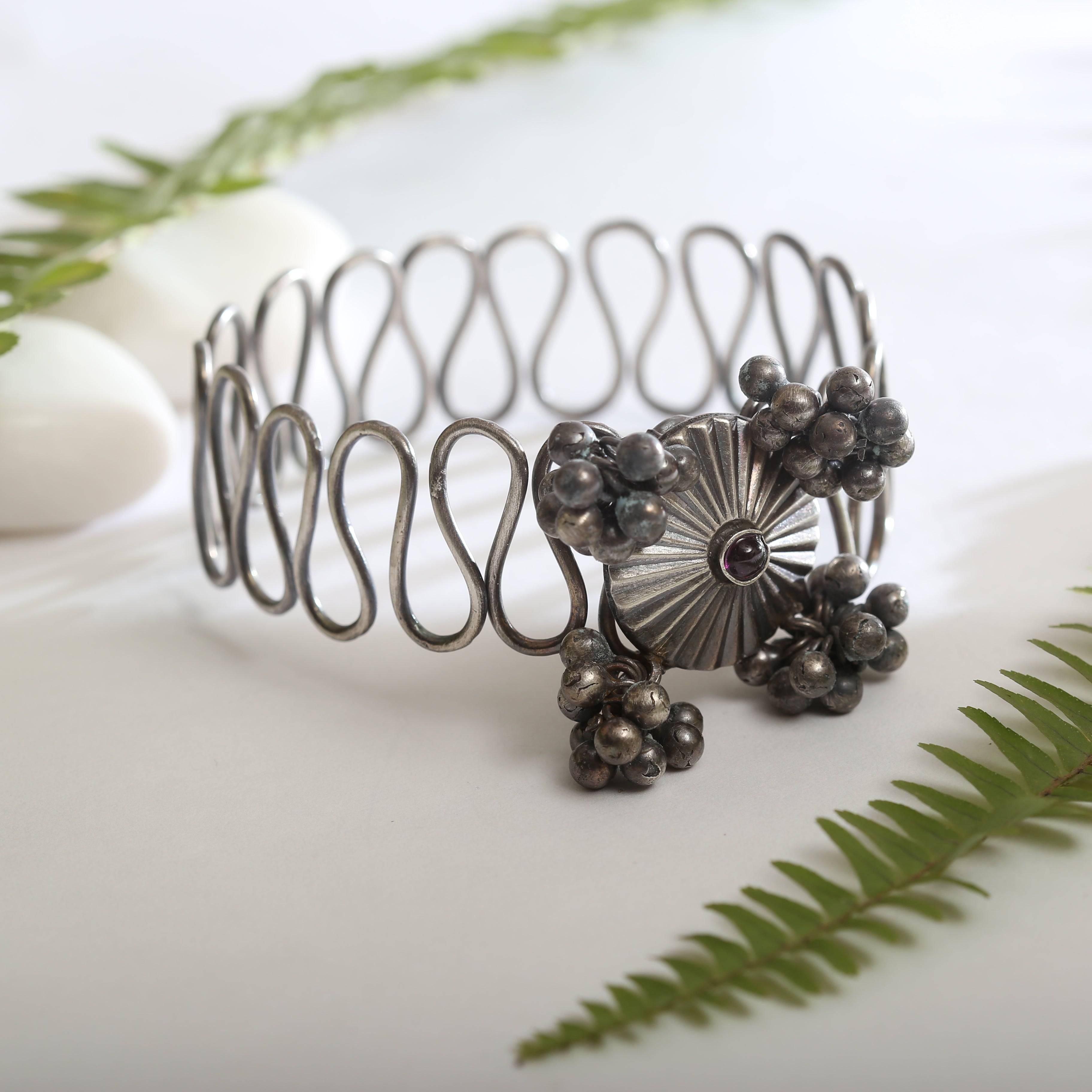 a close up of a metal bracelet on a table