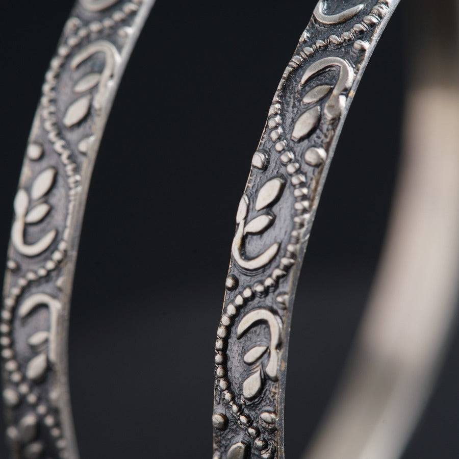 a close up of a metal object with a black background
