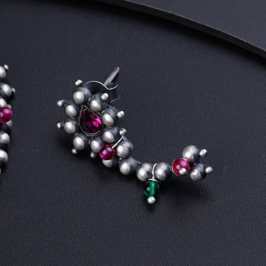 a close up of a pair of earrings on a table
