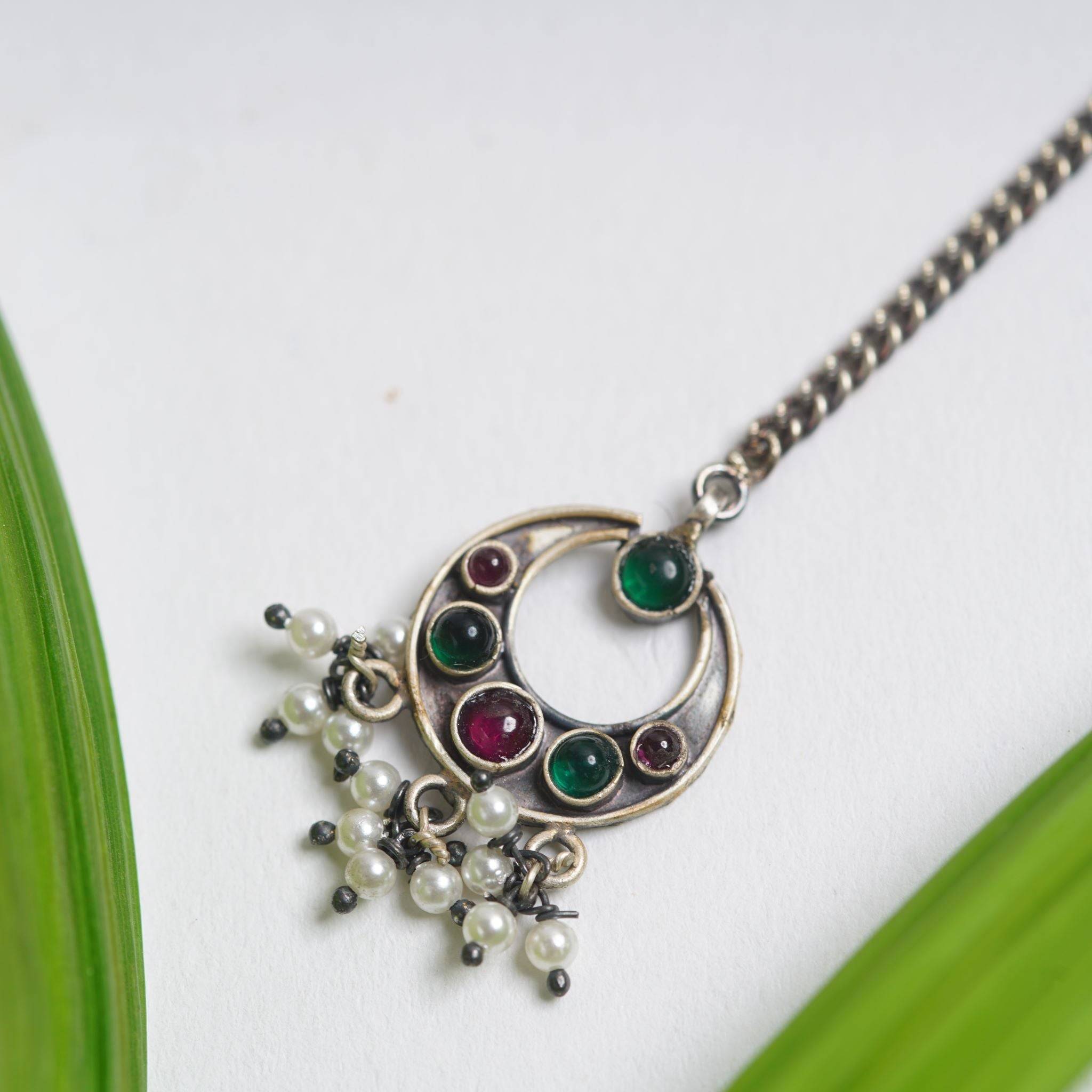 a close up of a necklace on a table