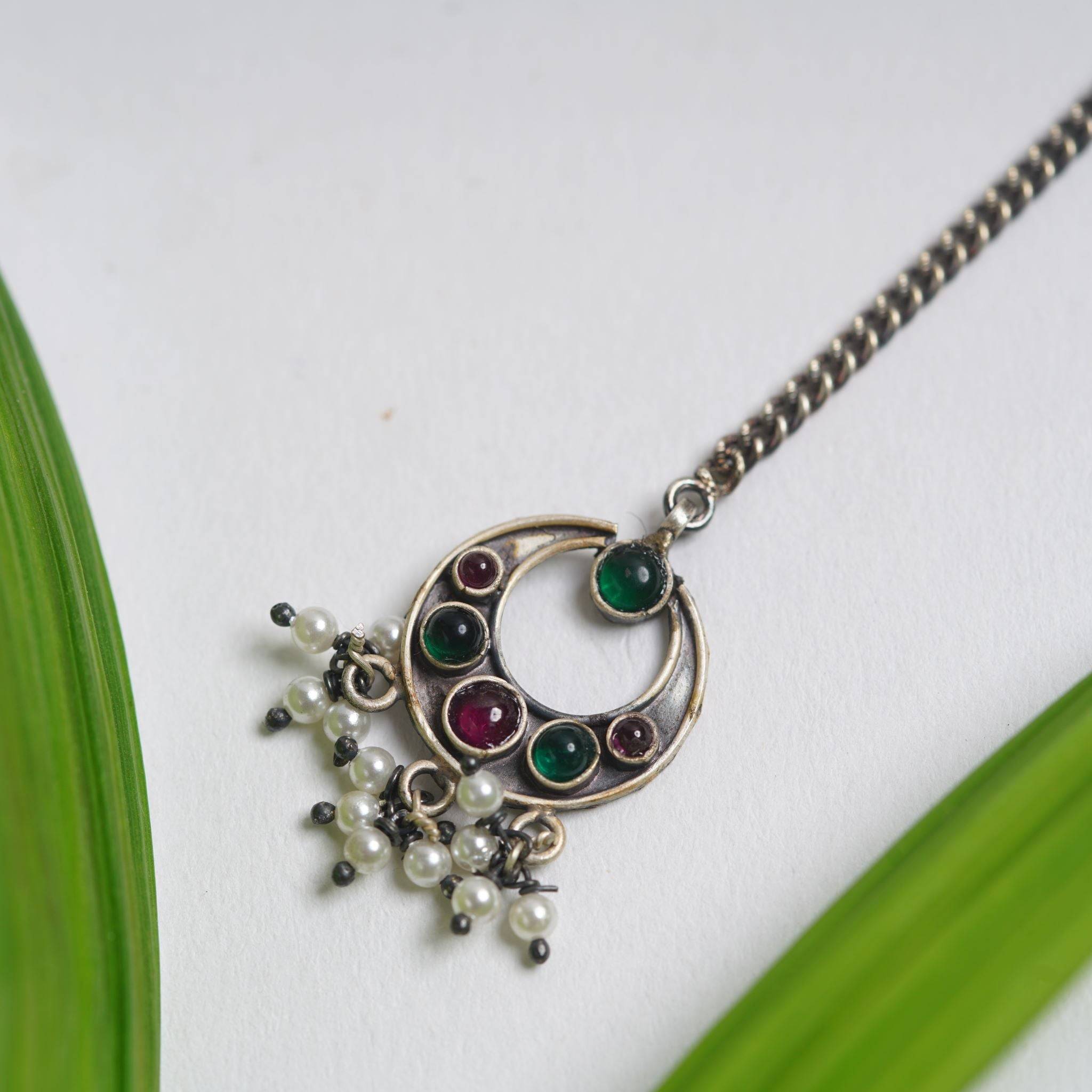 a close up of a necklace on a table