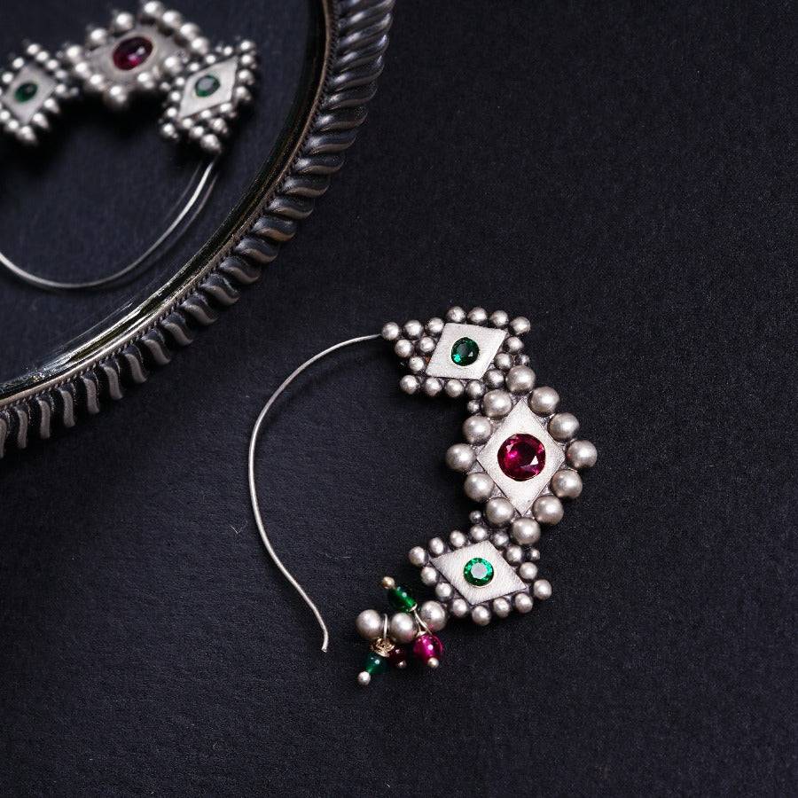 a pair of earrings sitting on top of a table