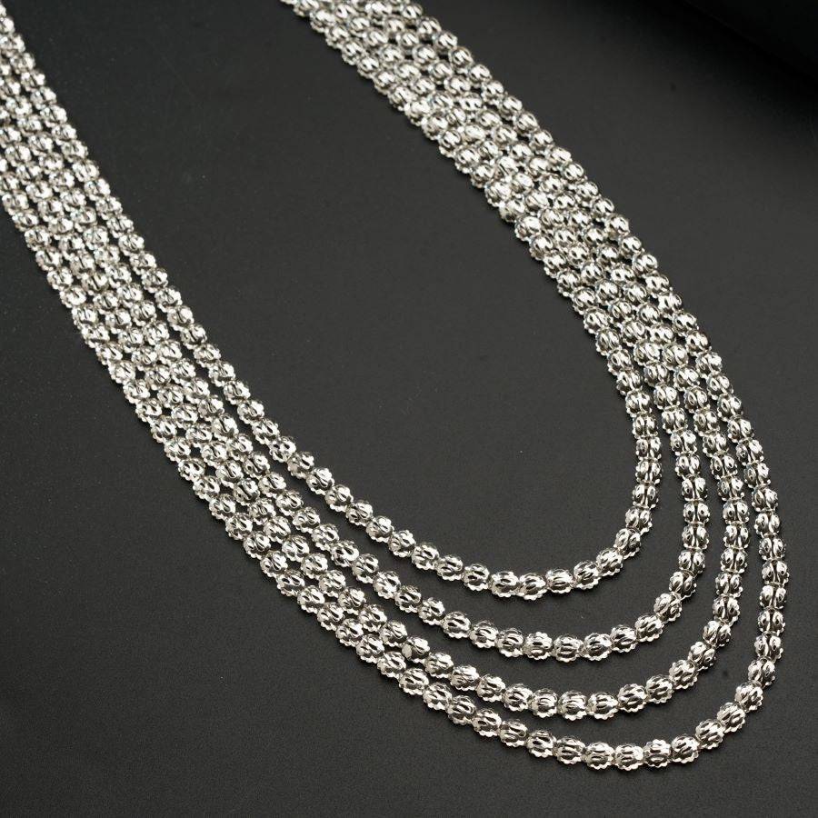 a silver chain is shown on a black surface