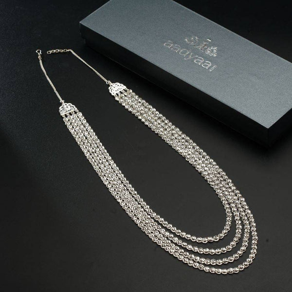 a set of three necklaces sitting on top of a table