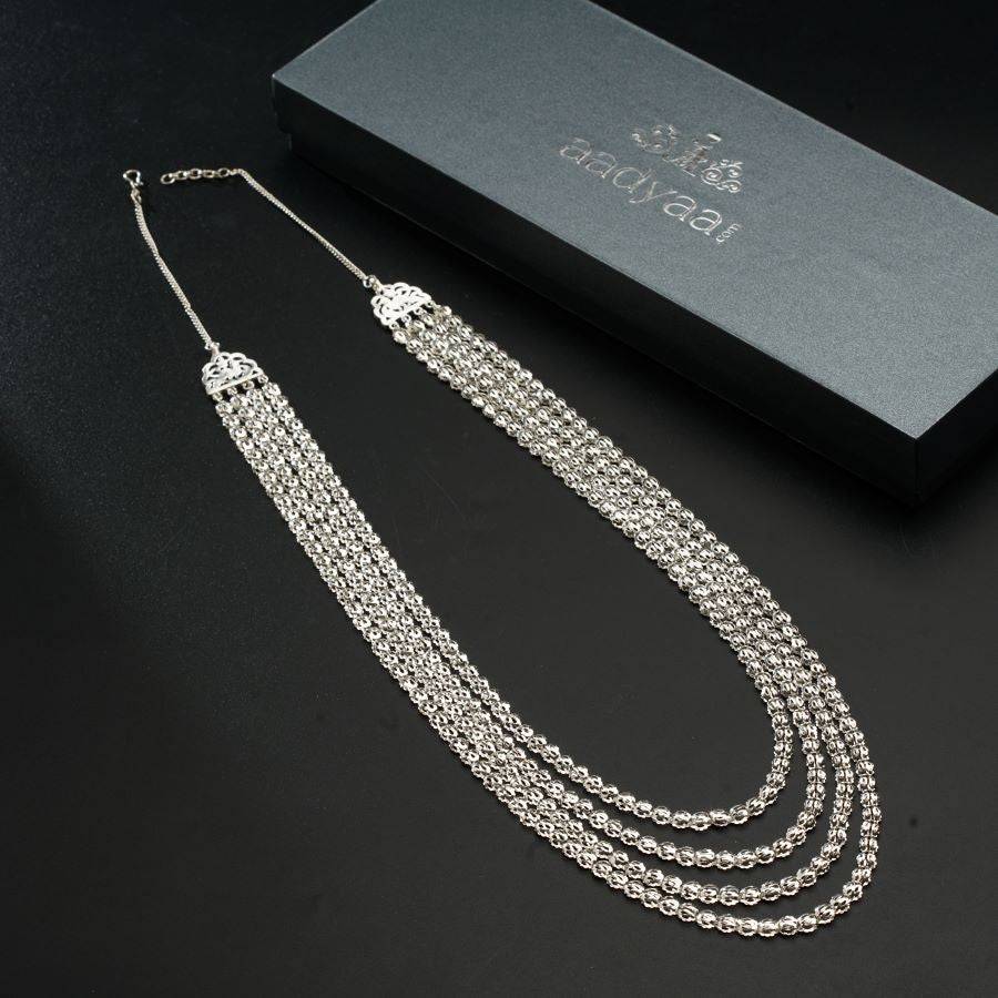 a set of three necklaces sitting on top of a table