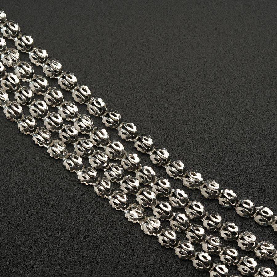 a close up of a chain on a black surface