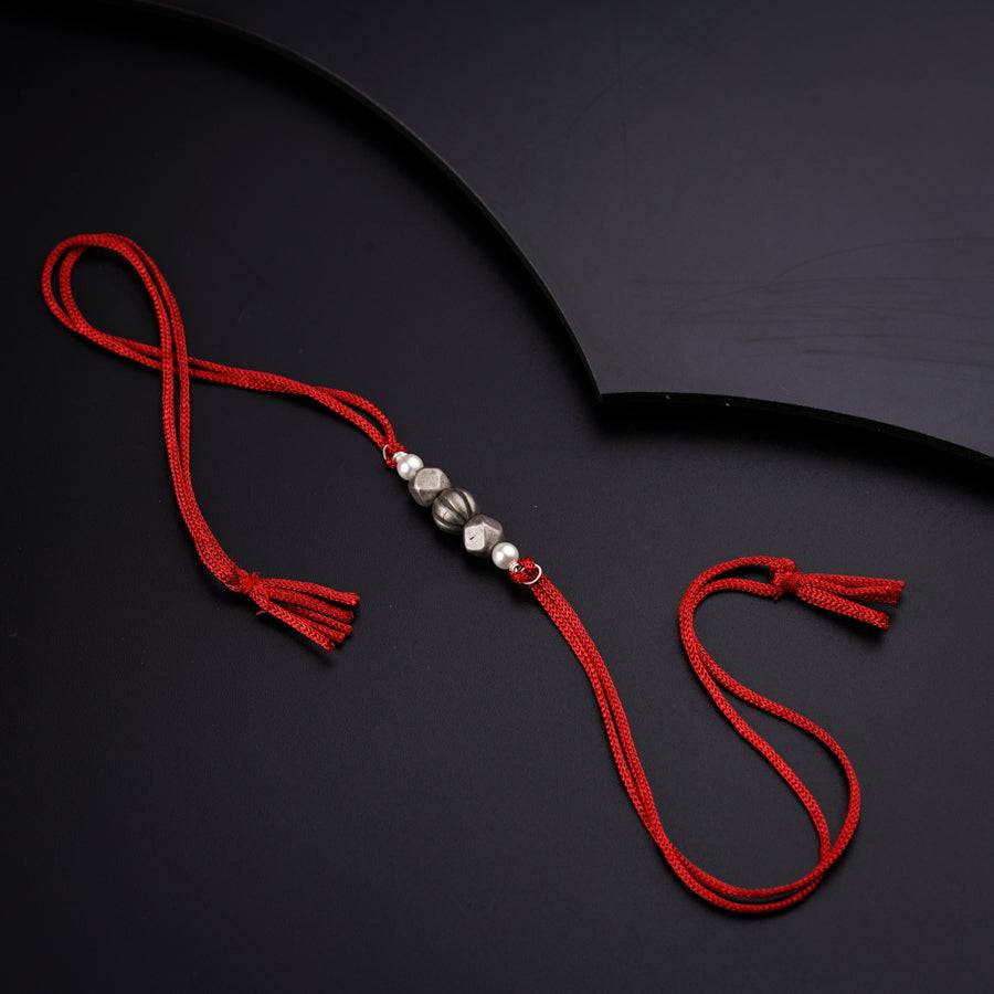 a black umbrella with a red string attached to it