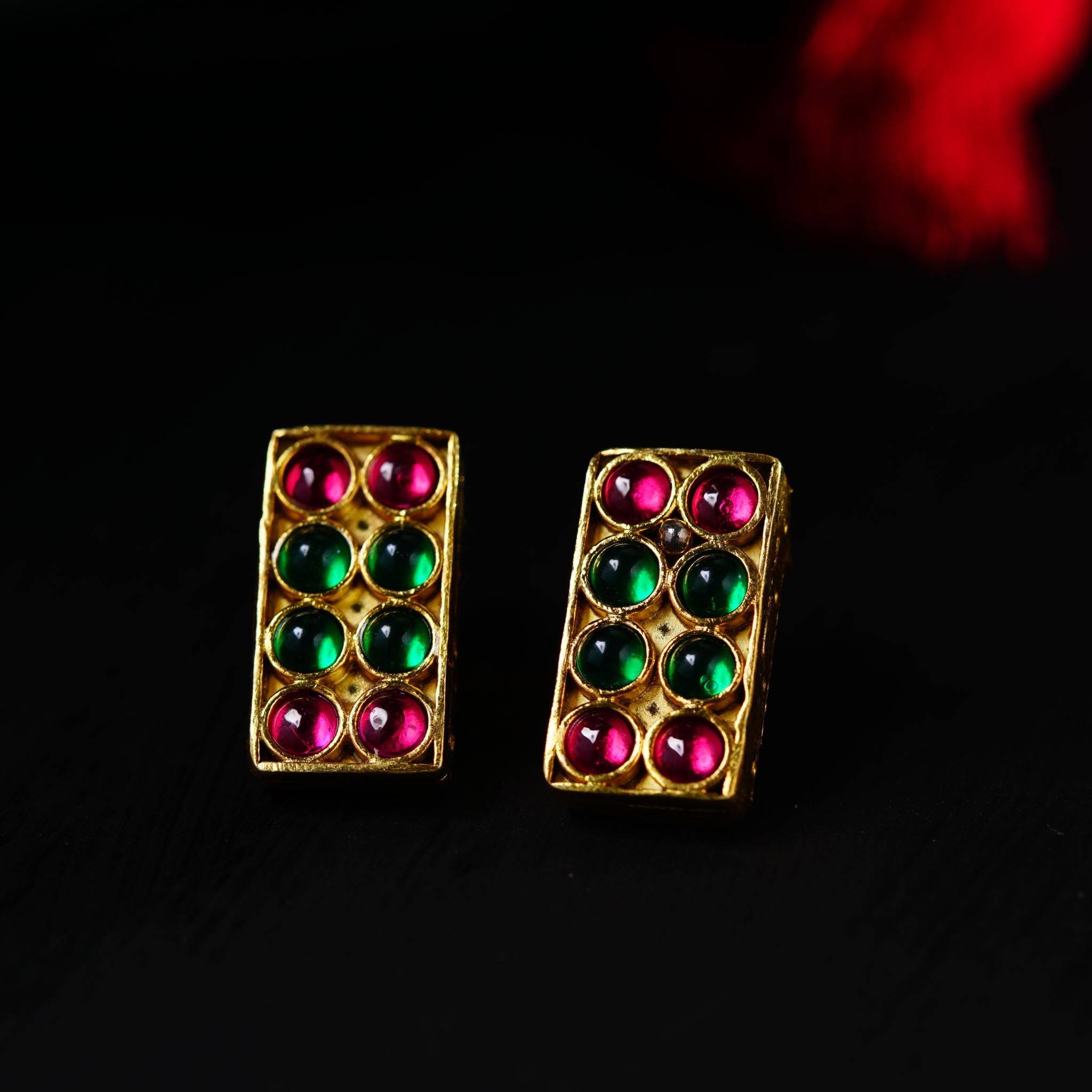 a pair of colorful earrings sitting on top of a table