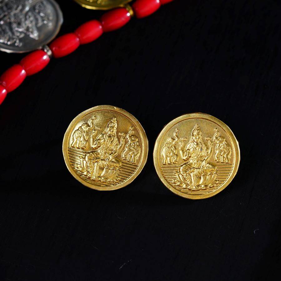 a close up of two gold coins on a table