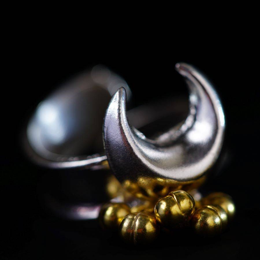 a close up of a metal object on a black background