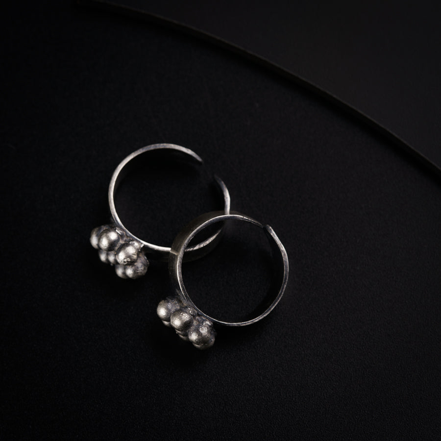 a pair of silver rings sitting on top of a table