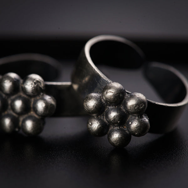a pair of silver rings sitting on top of a table