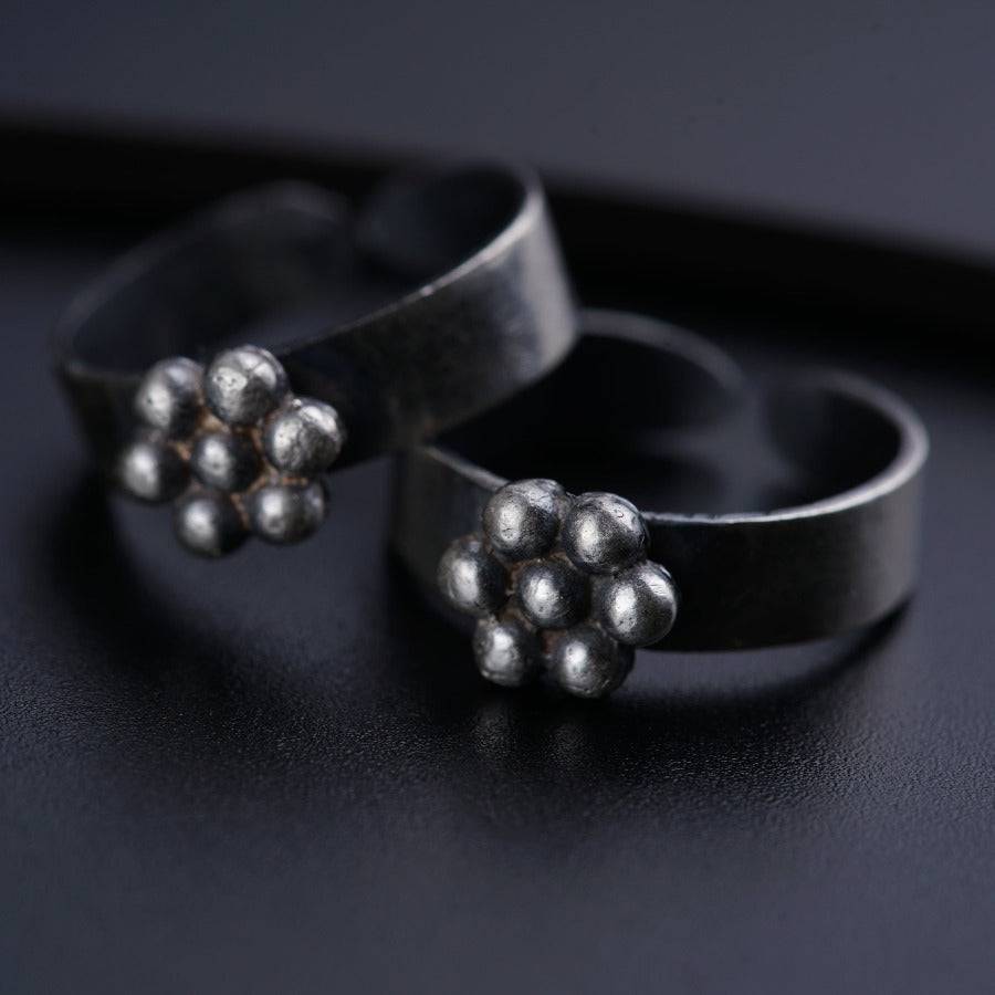 a pair of silver rings sitting on top of a table