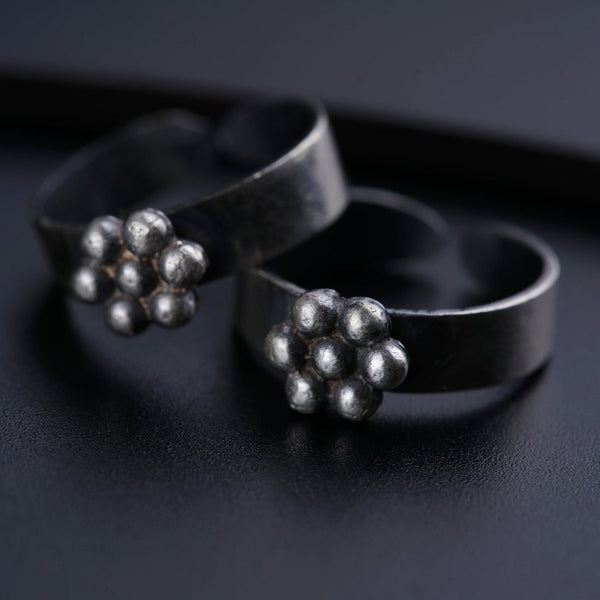 a pair of silver rings sitting on top of a table